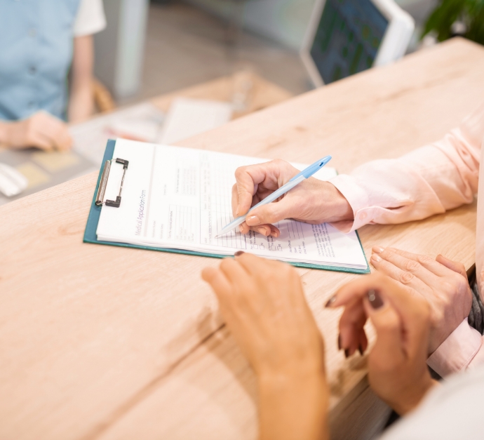 Staten Island dental patient filling out paperwork on clipboard