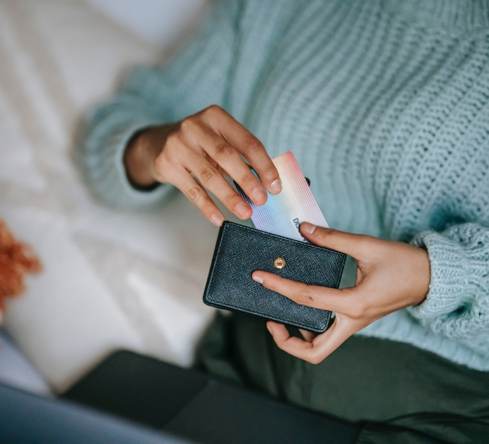 Person pulling a payment card out of their wallet