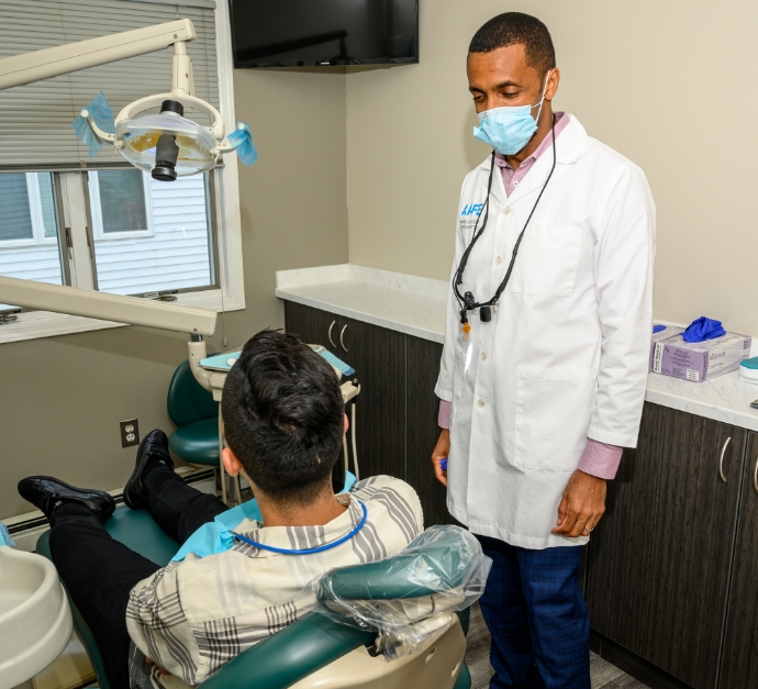 Doctor G talking to a patient in the dental treatment chair