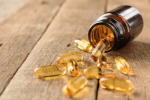 Vitamins spilling out of a bottle.