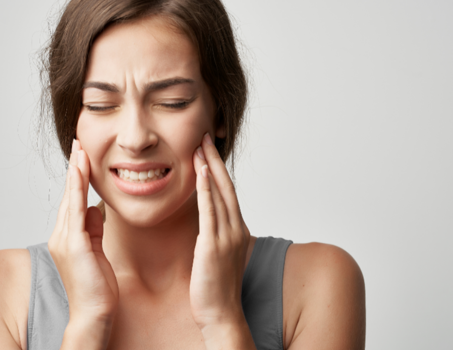 Woman holding jaw in pain